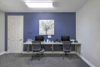 A room with two desks and two chairs.